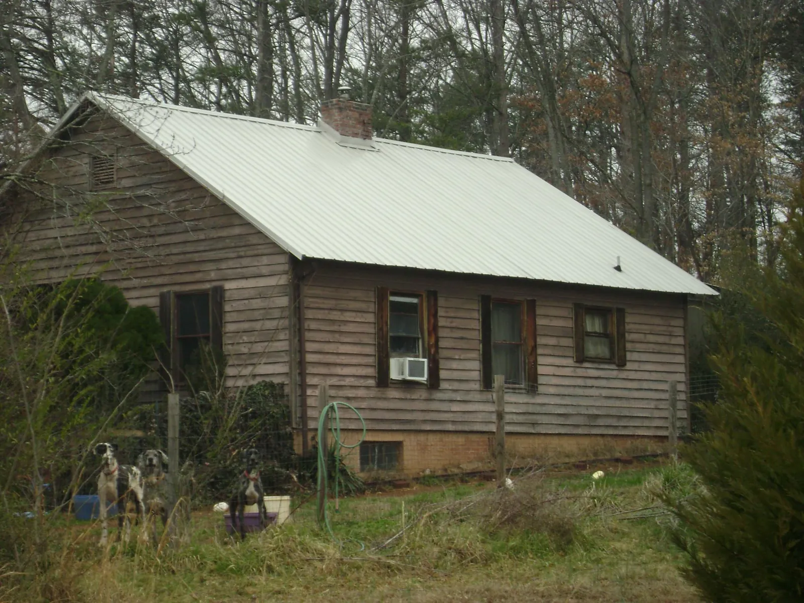 White metal roof on an old wood sided farmhouse, from a Asphalt Shingle Roof Repair job in Chatsworth